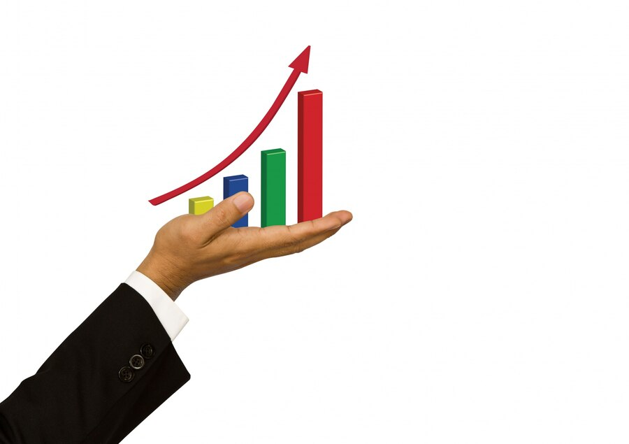 Hand holding a bar graph showing growth