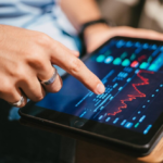 Man holding a tablet showing market trend